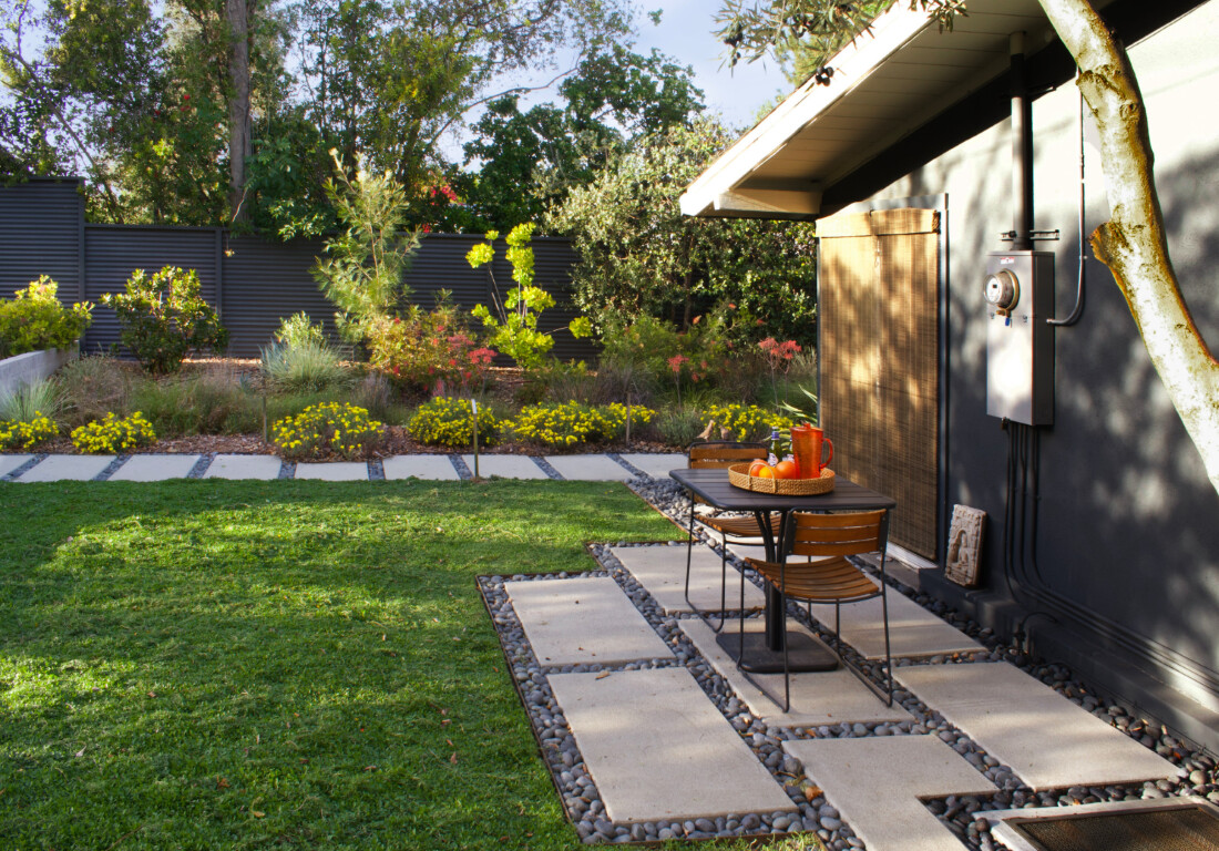 Low-maintenance concrete patio with decorative stepping stones